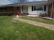 Well-maintained home featuring a brick pathway leading to the front entrance, landscaped with decorative stones and greenery at 13065 Allman Dr, Mooresville, IN 46158