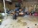 Cluttered garage featuring a riding lawn mower and various tools and equipment at 13065 Allman Dr, Mooresville, IN 46158