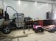Inside a large garage, you can see a small pink toy car and tools at 13065 Allman Dr, Mooresville, IN 46158