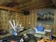 Interior garage view of cluttered, unfinished area with exposed insulation and city scene art at 13065 Allman Dr, Mooresville, IN 46158