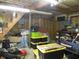 Cluttered garage featuring tools, storage containers, and exposed insulation at 13065 Allman Dr, Mooresville, IN 46158