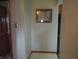 Hallway featuring neutral colored walls, tile floors, and wood trim at 13065 Allman Dr, Mooresville, IN 46158
