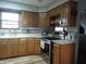Kitchen featuring natural wood cabinets, light countertops, and stainless steel appliances at 13065 Allman Dr, Mooresville, IN 46158