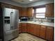 Kitchen space with stainless steel refrigerator and natural wooden cabinets at 13065 Allman Dr, Mooresville, IN 46158