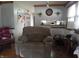 Inviting living room with chair, hard wood floors, and open view into kitchen at 13065 Allman Dr, Mooresville, IN 46158