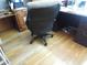 Corner of a home office with wood floors, desk, and rolling office chair at 13065 Allman Dr, Mooresville, IN 46158