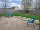Cozy backyard featuring a circular brick patio, lush green grass, a privacy fence, and a blossoming tree at 1317 Mulberry Ct, Greenfield, IN 46140