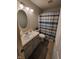 Cozy bathroom featuring a vanity with sink, toilet, and shower with blue and white curtain at 1317 Mulberry Ct, Greenfield, IN 46140