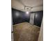 Bedroom with dark blue walls, plush carpeting, and a decorative light fixture at 1317 Mulberry Ct, Greenfield, IN 46140
