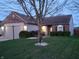 Charming single-story home featuring a brick facade, attached garage, and manicured front lawn at 1317 Mulberry Ct, Greenfield, IN 46140