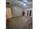 Spacious living area with neutral colors, ceiling fan, and french doors leading to the backyard at 1317 Mulberry Ct, Greenfield, IN 46140