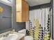 Well-lit bathroom featuring a vanity, mirror, toilet, cabinet, and decorative shower curtain at 14444 Black Farm Dr, Noblesville, IN 46060