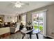 Bright dining area with a view of the living room, a ceiling fan, and sliding glass doors to the yard at 14444 Black Farm Dr, Noblesville, IN 46060