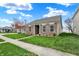 Beautifully landscaped home on a corner lot, with a lush green lawn and a tidy sidewalk at 14444 Black Farm Dr, Noblesville, IN 46060