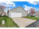 A two-car garage with vinyl siding, a well-kept lawn, and a concrete driveway at 14444 Black Farm Dr, Noblesville, IN 46060