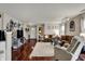 Open-concept living area showcasing hardwood floors, stylish decor, and a cozy seating arrangement at 14444 Black Farm Dr, Noblesville, IN 46060