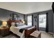 Relaxing main bedroom featuring wood furniture, neutral colors, and natural light from large windows at 14444 Black Farm Dr, Noblesville, IN 46060