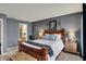 Serene main bedroom with dark gray walls, a wooden bed frame, and views to the ensuite bath at 14444 Black Farm Dr, Noblesville, IN 46060