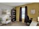 Office featuring a white chair, black shelving, and dark window treatments at 14444 Black Farm Dr, Noblesville, IN 46060