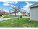A lovely yard with a street view, a single tree, and clear skies above the adjacent home at 14444 Black Farm Dr, Noblesville, IN 46060