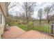 Back deck surrounded by beautiful lush trees, making it perfect for relaxing in nature at 1527 N Washington St, Danville, IN 46122