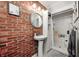 Industrial style bathroom featuring brick accent wall, vessel sink, and a glass door shower at 1527 N Washington St, Danville, IN 46122