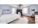 Bright bedroom with blue walls, hardwood floors, white bedding, and large windows with natural light at 1527 N Washington St, Danville, IN 46122
