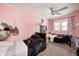 Pink bedroom with two beds, a ceiling fan, carpet, and plenty of natural light from the window at 1527 N Washington St, Danville, IN 46122