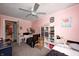 A pink bedroom with a ceiling fan, two beds, carpet, and a view to a bathroom at 1527 N Washington St, Danville, IN 46122
