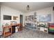 Bright bonus room with a wooden desk, storage shelves filled with games, and a play kitchen at 1527 N Washington St, Danville, IN 46122