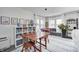 Bright dining area featuring a rustic table, ample seating, and large windows offering plenty of natural light at 1527 N Washington St, Danville, IN 46122