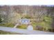 Charming cottage-style home boasts dormer windows and a quaint deck, nestled in a wooded landscape at 1527 N Washington St, Danville, IN 46122