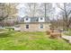 Well-maintained stone house with dormers and mature trees offering a serene setting in the backyard at 1527 N Washington St, Danville, IN 46122