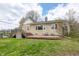 Charming stone house featuring a wooden deck with seating and a well-maintained grassy lawn at 1527 N Washington St, Danville, IN 46122