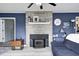 Cozy fireplace with stone surround and mantel, set against blue paneled walls, creating a focal point in the living space at 1527 N Washington St, Danville, IN 46122