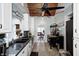Bright kitchen featuring white cabinets, tile floors, butcher block island and a view into the dining room at 1527 N Washington St, Danville, IN 46122
