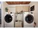 A well-lit laundry room featuring high-end, front-loading washer and dryer units for convenient chores at 1527 N Washington St, Danville, IN 46122
