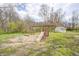 Backyard playground with a slide, swings, and a seating area for to enjoy outdoors at 1527 N Washington St, Danville, IN 46122