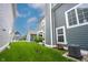 Manicured backyard featuring a lush lawn, partial view of the house, and neatly trimmed greenery at 1534 Cloverdon Dr, Westfield, IN 46074