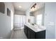 Bathroom featuring a double sink vanity, tiled floor, and a shower with a decorative curtain at 1534 Cloverdon Dr, Westfield, IN 46074