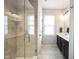 Modern bathroom featuring tile shower, dark cabinets, double sink, and natural light at 1534 Cloverdon Dr, Westfield, IN 46074
