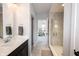 Stylish bathroom with tiled shower, and vanity with double sinks and dark cabinets at 1534 Cloverdon Dr, Westfield, IN 46074