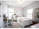 Bright bedroom with desk, cozy bed, natural light, and a wooden decorative shelf at 1534 Cloverdon Dr, Westfield, IN 46074
