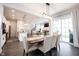 Open-concept dining area with wood table, modern light fixture, and views of the kitchen and living room at 1534 Cloverdon Dr, Westfield, IN 46074