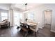Bright dining room featuring a long wood table with bench seating and modern light fixture at 1534 Cloverdon Dr, Westfield, IN 46074