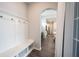 Bright entryway with white bench and hooks offers a view to the kitchen and dining area at 1534 Cloverdon Dr, Westfield, IN 46074