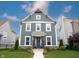Charming two-story home with a blue-gray exterior, inviting front porch, and manicured lawn at 1534 Cloverdon Dr, Westfield, IN 46074