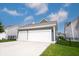 A spacious three-car garage with white doors complements the home's blue-grey exterior, offering ample parking and storage at 1534 Cloverdon Dr, Westfield, IN 46074