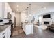 This kitchen is modern with stainless appliances, granite countertops and flows into the open living room with a fireplace at 1534 Cloverdon Dr, Westfield, IN 46074