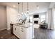 A kitchen island with granite countertops, sleek appliances, and open views of the living room with fireplace at 1534 Cloverdon Dr, Westfield, IN 46074